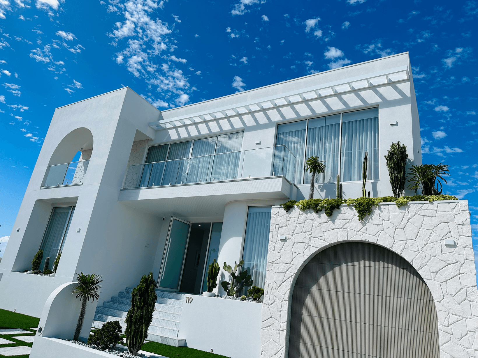 Exterior of CMA home with curves and arch facade