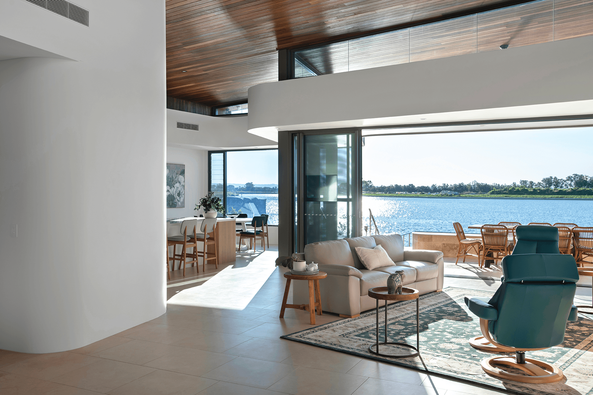 Interior of home showing curved walls and water view